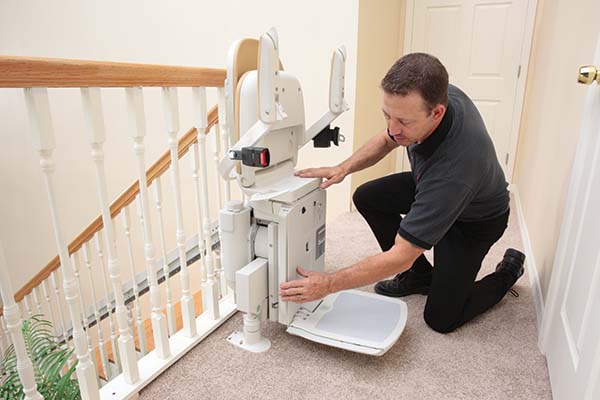 Man inspecting a stairlift
